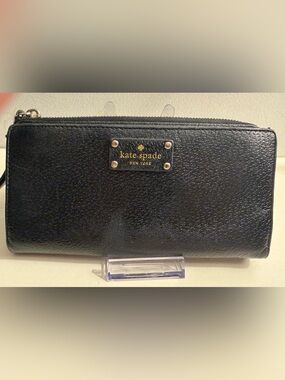 Kate Spade black leather continental wallet with gold lettering.